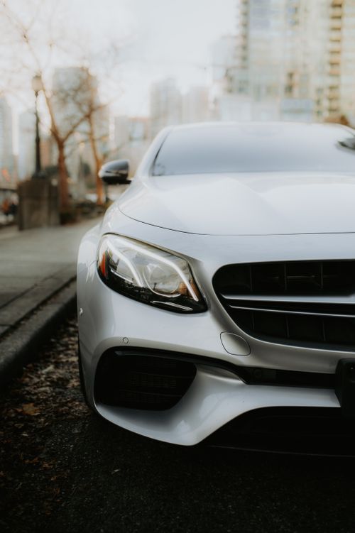 Free Elegant luxury car parked in a city environment, showcasing sleek modern design. Stock Photo