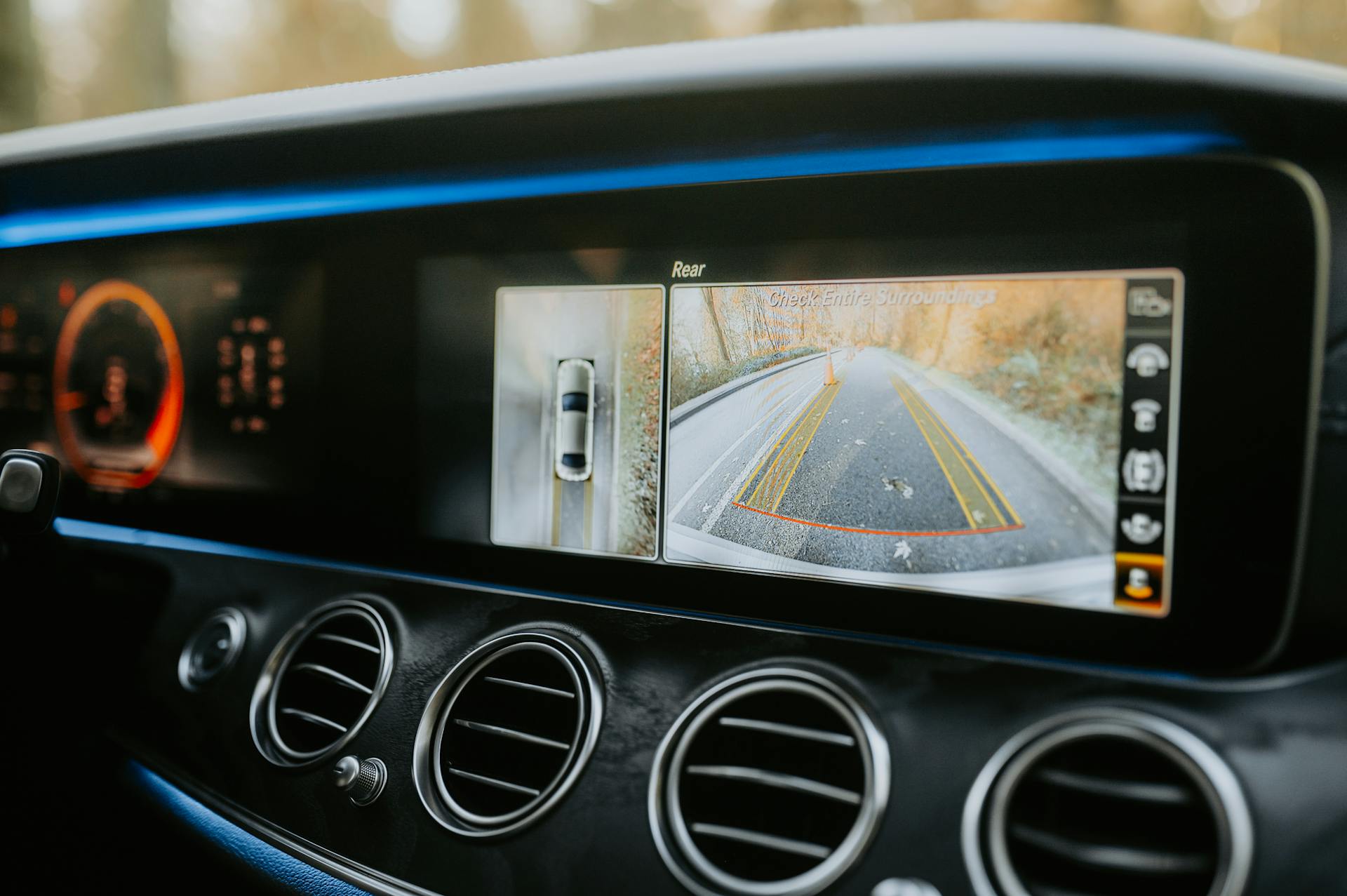 Close-up of a car dashboard showcasing a rear-view camera display and modern electronics.