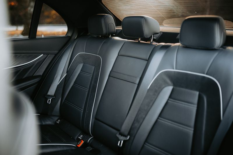 Empty leather rear bench of a reserved car, photo by Luke Miller on Pexels