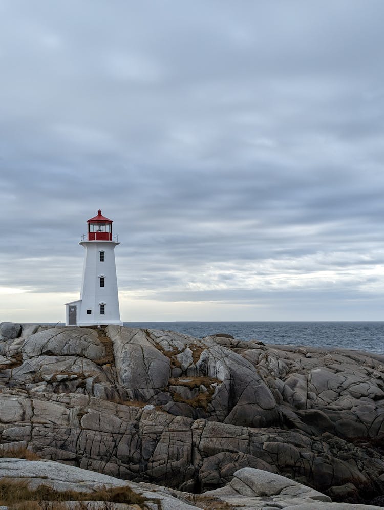 White And Red Lighthouse On The Shore