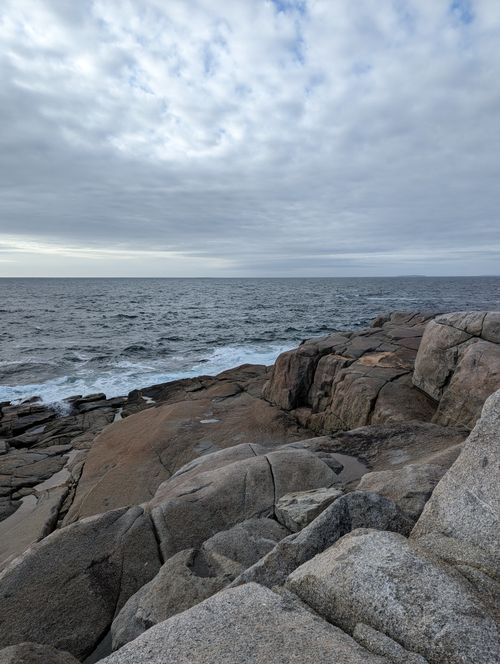 Free Explore the rugged beauty of Peggys Cove's rocky coastline and expansive ocean view. Stock Photo