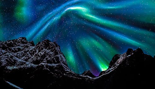 Heavy northern lights activity on sky in Lofoten islands