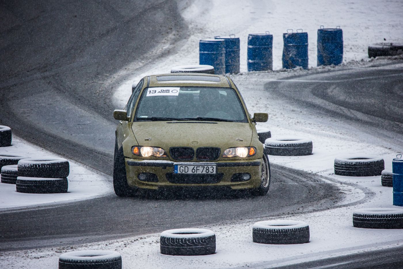 A BMW sliding sideways on a snow-covered track