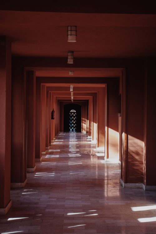 Free A sunlit corridor with shadows creating a symmetrical pattern in Red Sea Governorate, Egypt. Stock Photo