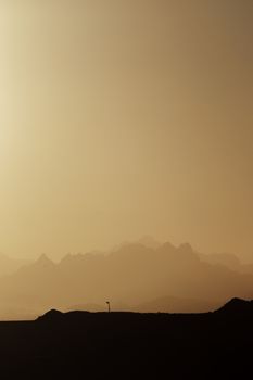 Silhouette of mountains at sunrise with mist in Hurghada, Egypt, capturing serene natural beauty.