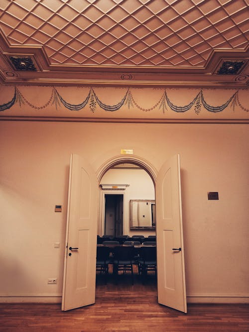 A View of Chairs and Table on an Open Door