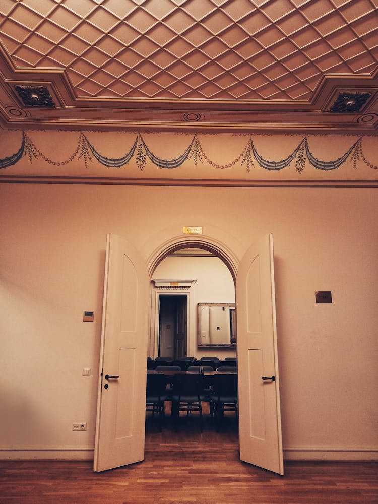 A View Of Chairs And Table On An Open Door