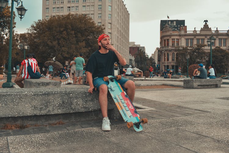 A Man Smoking Cigarette In The Park