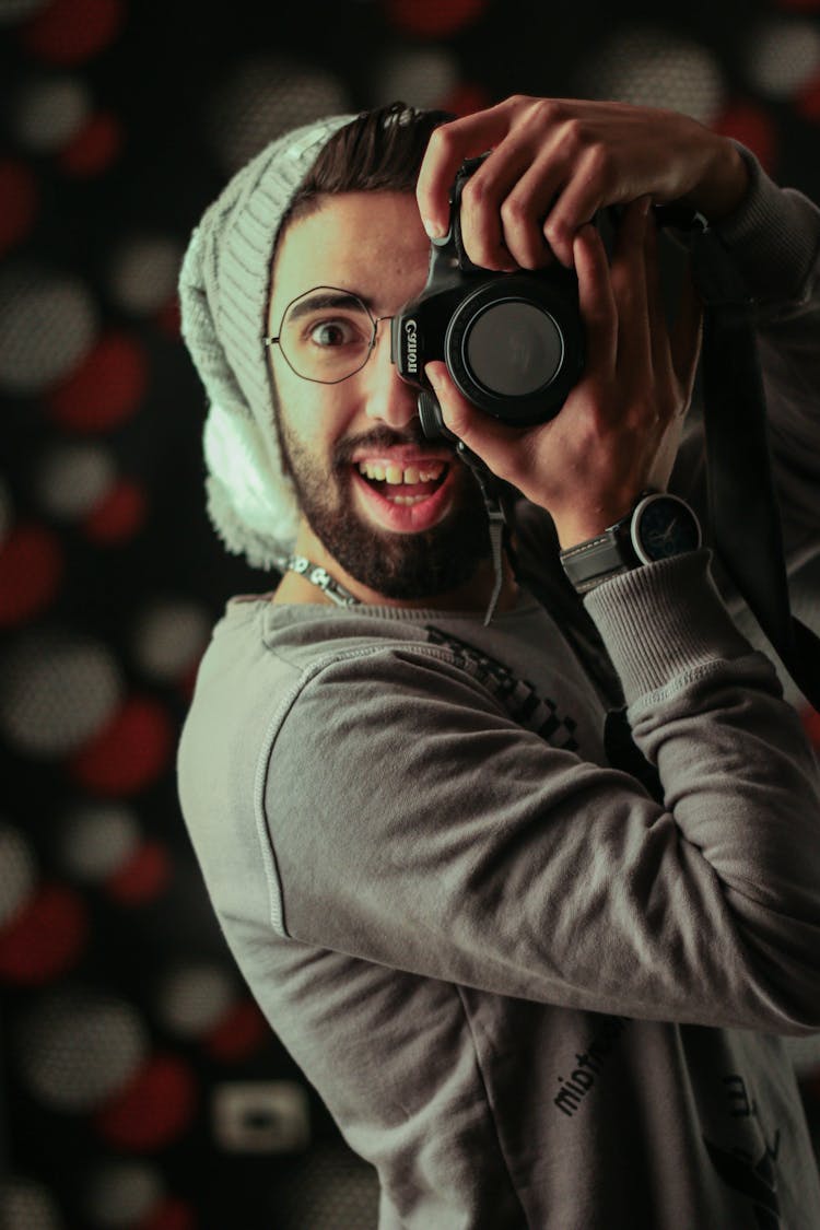 Man Holding Black Canon Dslr Camera