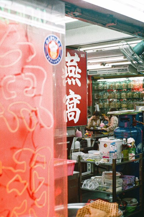 Free Colorful street market in Bangkok, showcasing traditional Thai shop and signage. Stock Photo