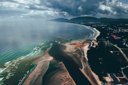 Aerial view of Balok Beach in Pahang, Malaysia, showcasing dramatic coastlines and stormy skies.
