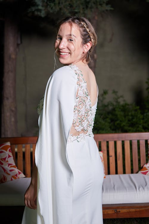 A Woman in White Dress Looking Over Her Shoulder