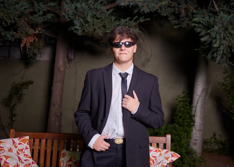 A Man In A Suit Wearing Sunglasses 