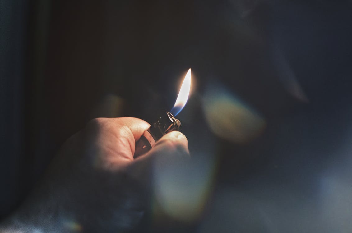 Free Person Holding Lighter Stock Photo