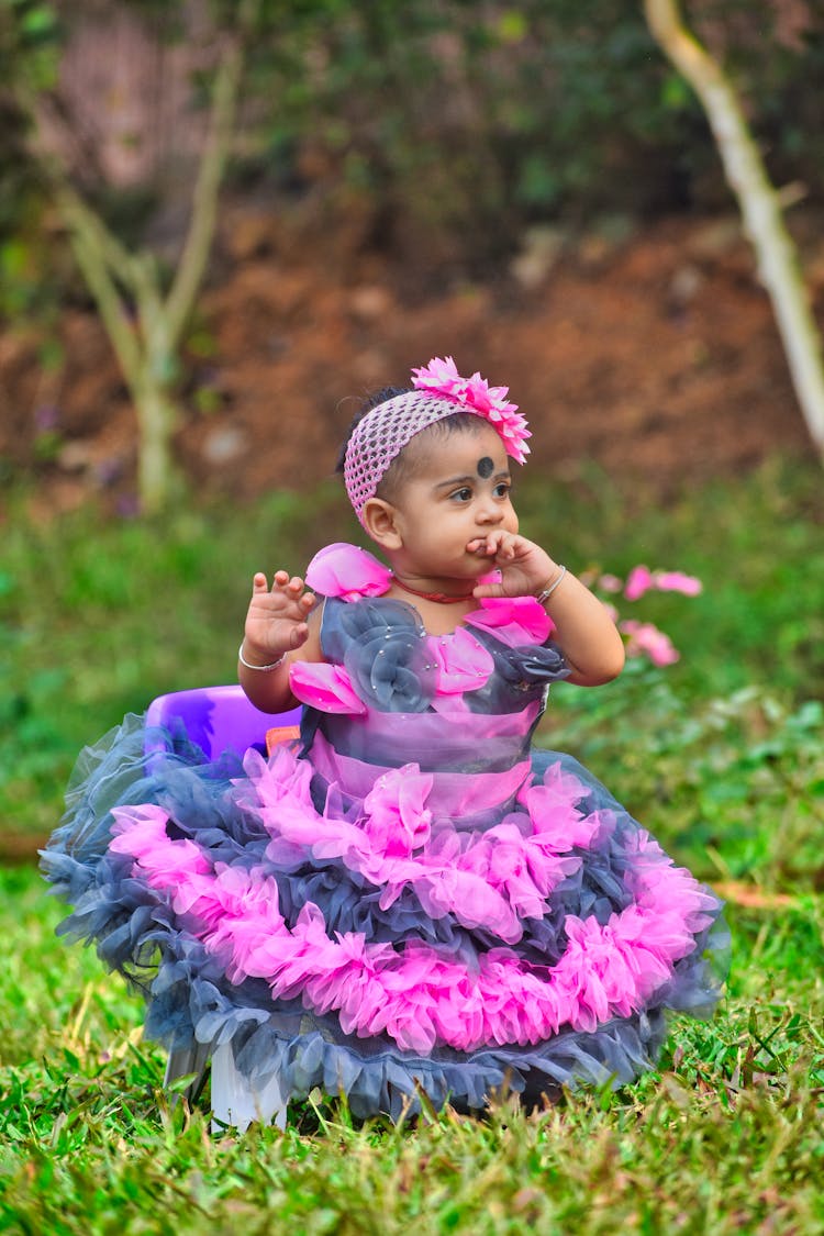 A Baby In Pink And Blue Dress