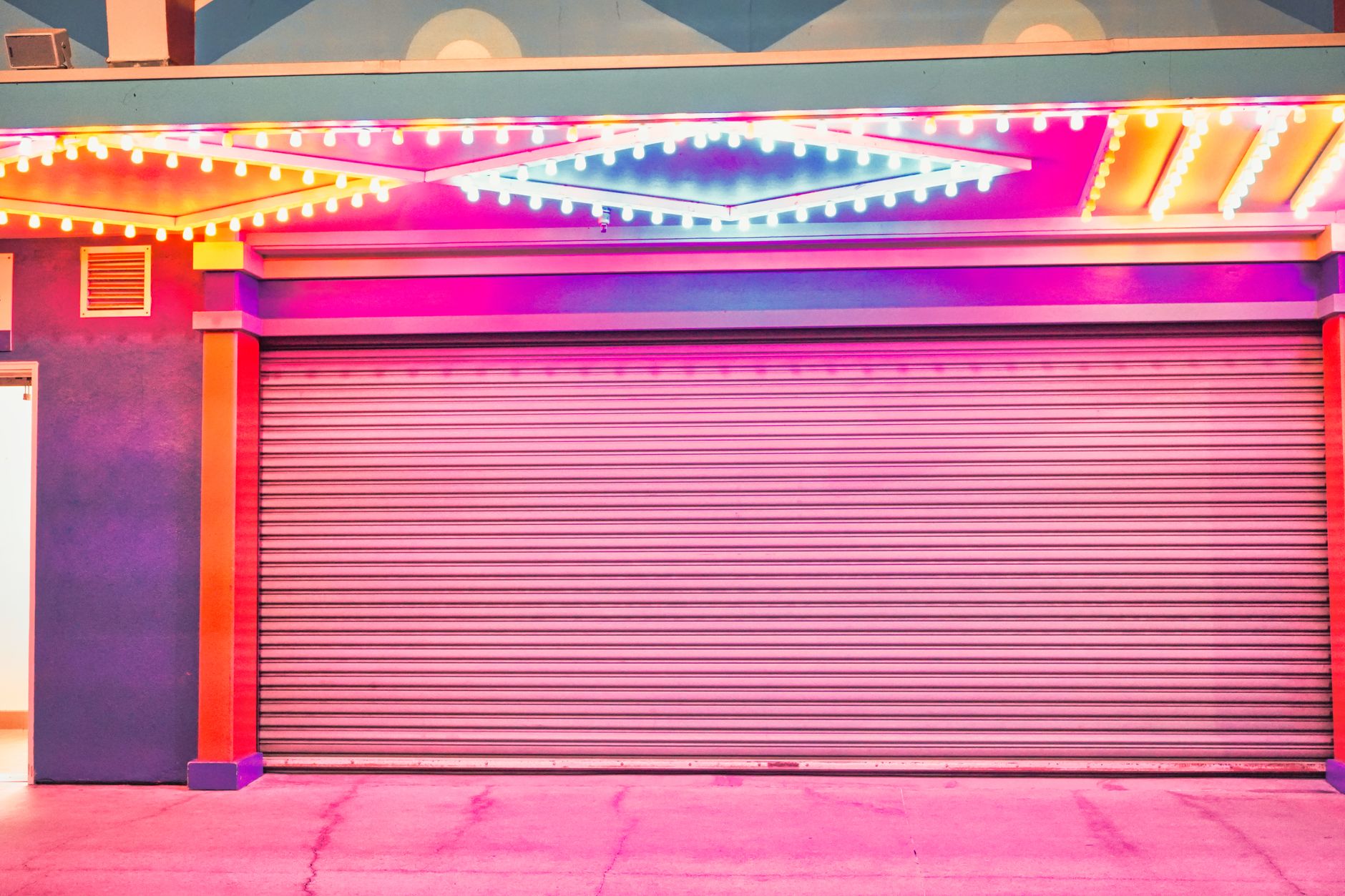 A brightly colored garage door illuminated by vivid neon lights in a retro style setting.
