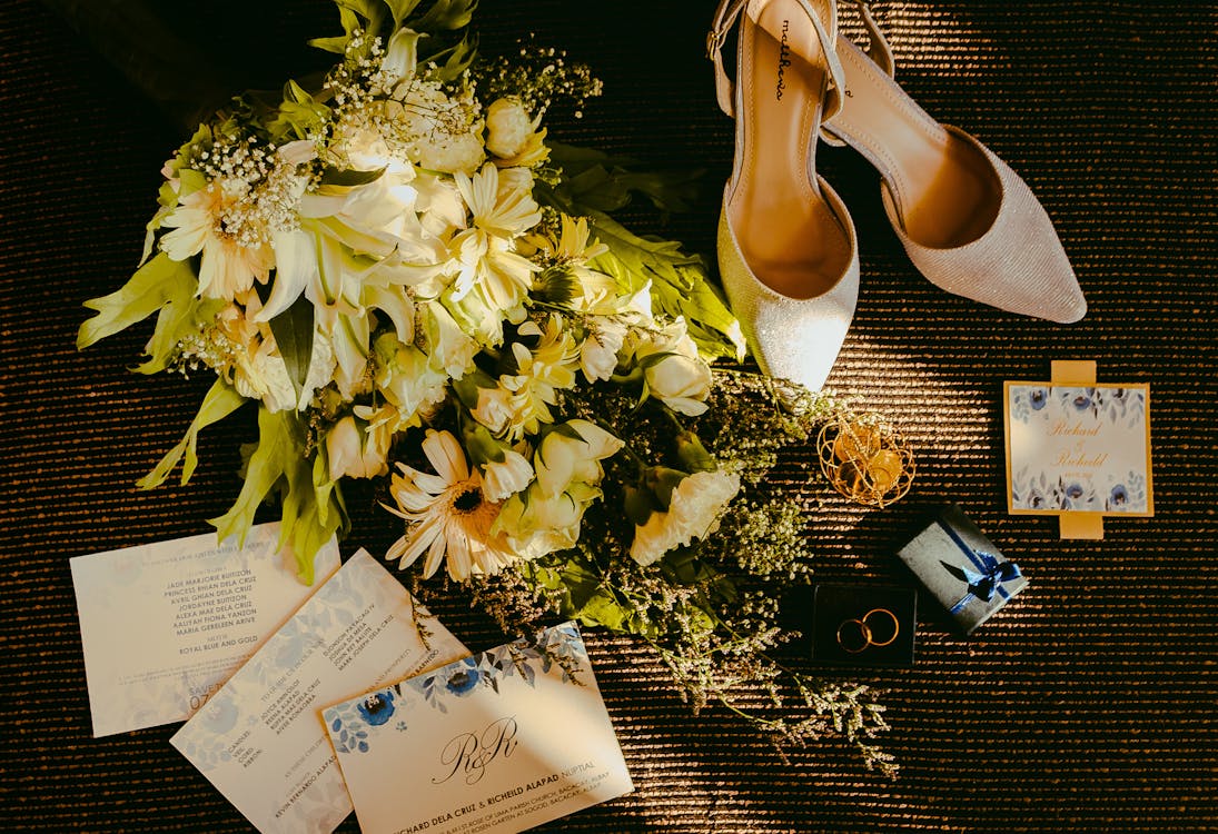 Free Pair Of Beige Shoes Beside Bouquet Stock Photo