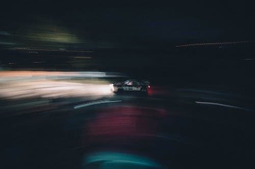 Speeding Race Car Among Blurry Lights