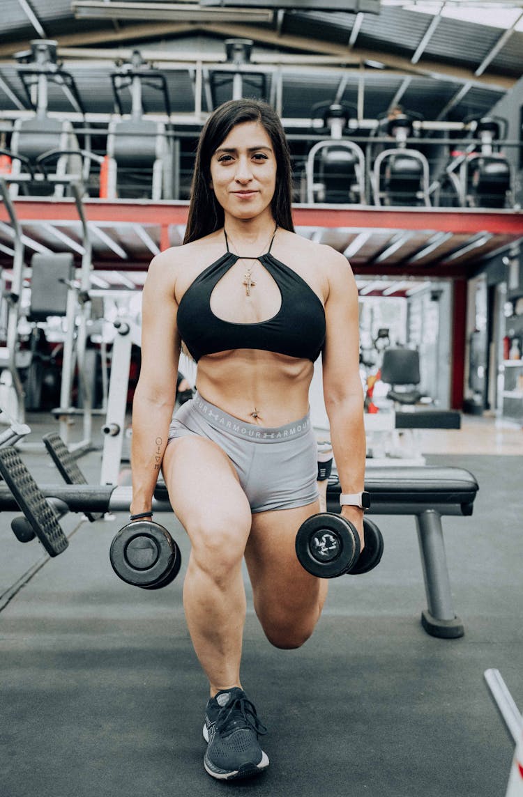 Woman Posing With Kettlebells