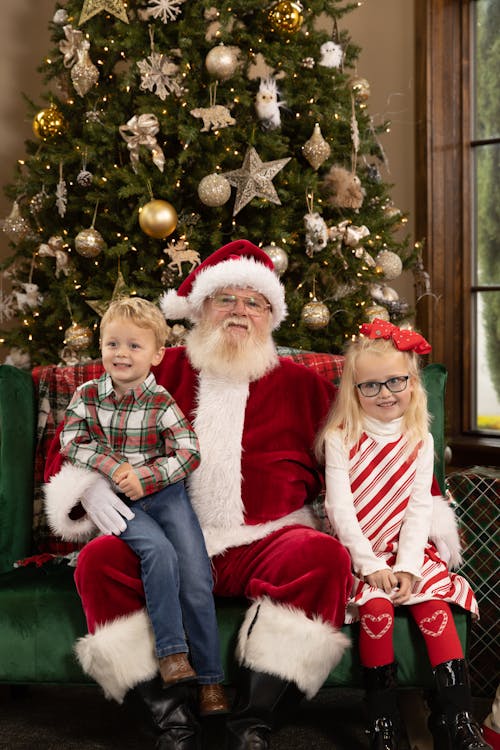 A Man in Santa Claus Costume Sitting Together with Children