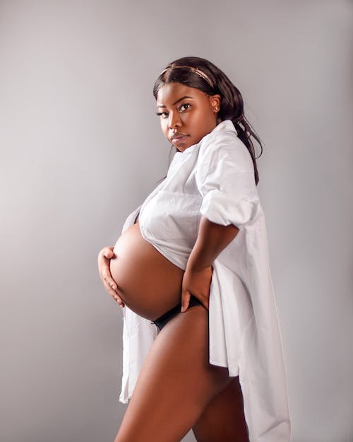 A Pregnant Woman in White Long Sleeves