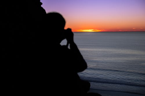 Silhouette of a Person on the Beach During Sunset