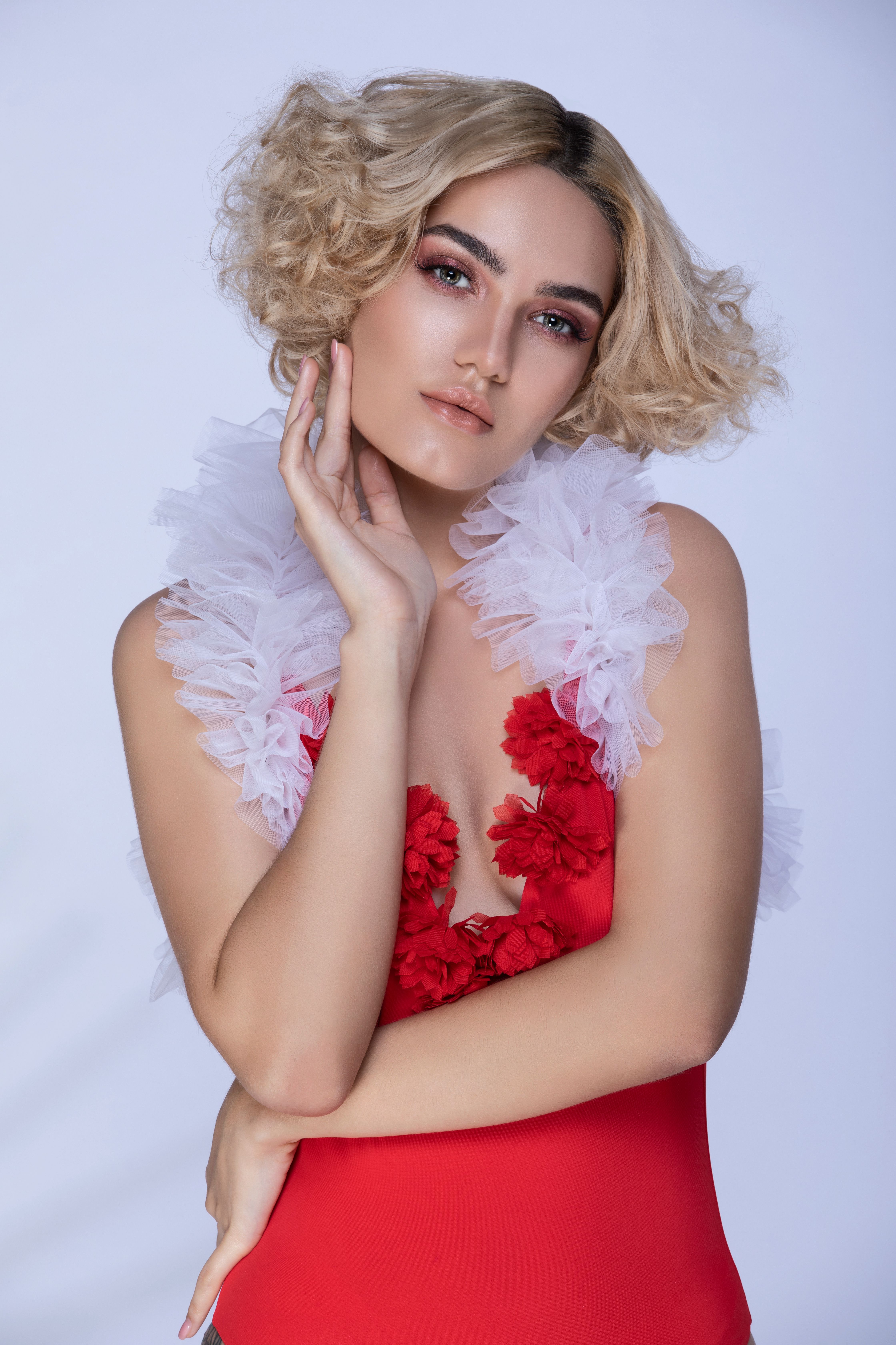 A Woman in White and Red Dress Posing at the Camera · Free Stock Photo
