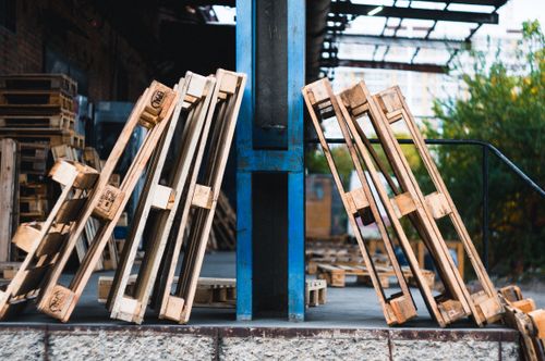Free Close-up view of wooden pallets in an outdoor industrial warehouse setting. Stock Photo