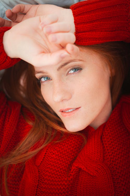 A Woman in Red Sweater Smiling at the Camera