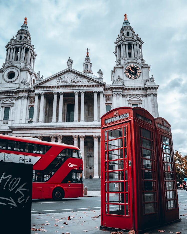 Telephone Booth On The Side Of The Road Near Moving Double Decker Bus And St. Paul Cathedral