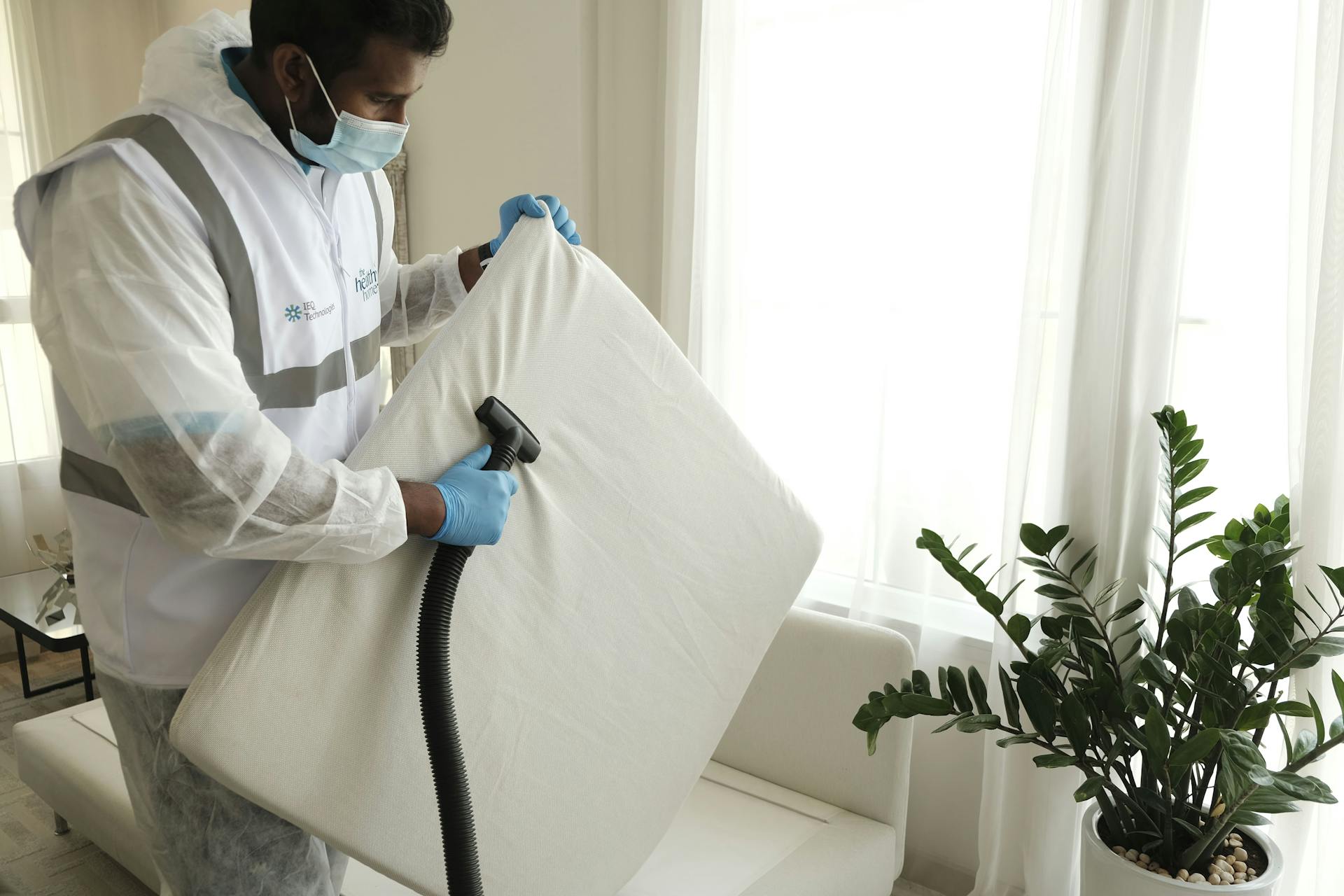 Cleaning Service Worker Vacuuming the House