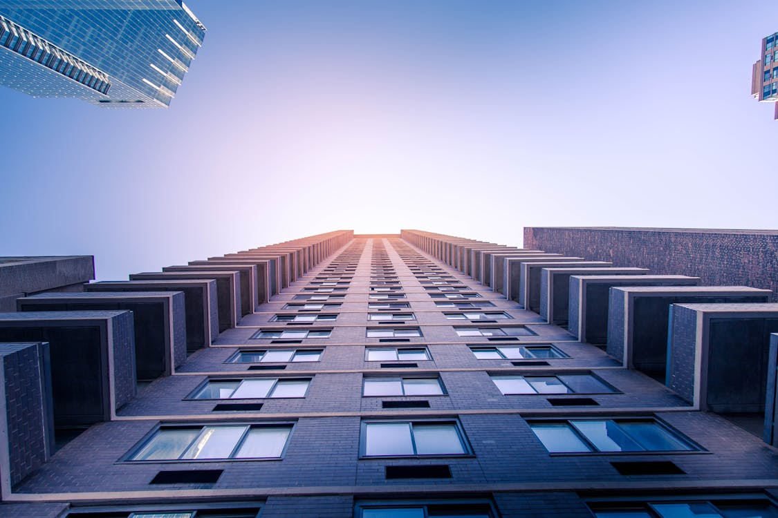 Worm's-eye View Photography of Gray Concrete Buildings Under Blue Sky