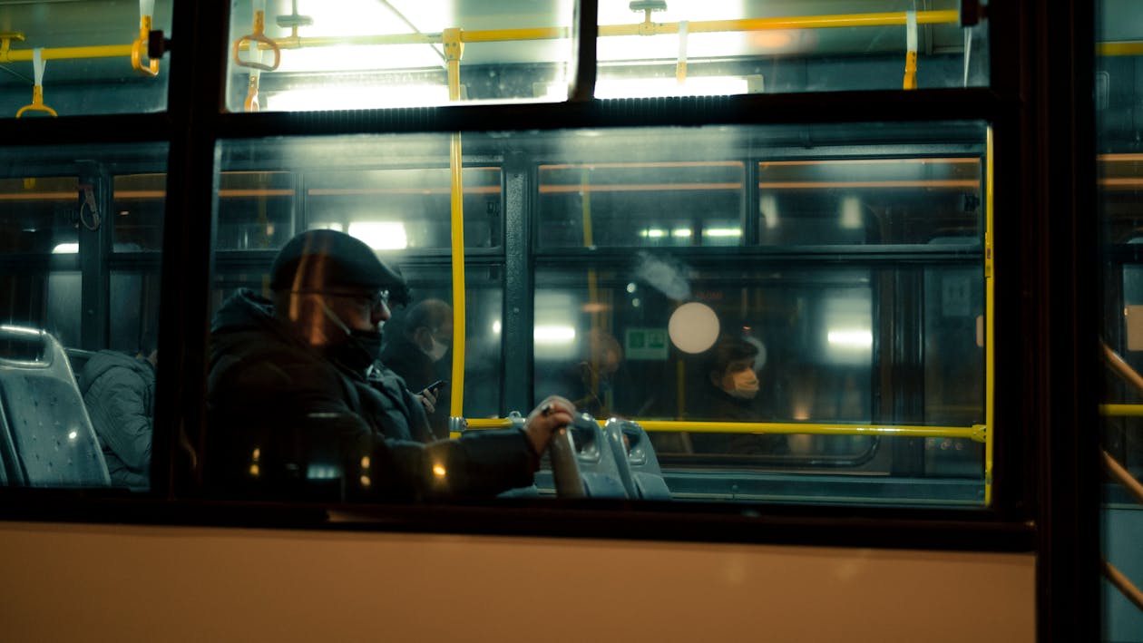 People in a Bus at Night Photographed from the Outside · Free Stock Photo