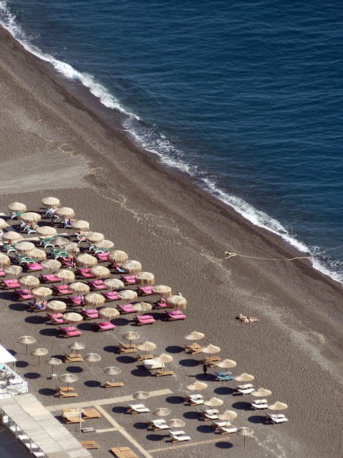 Lounge Chairs and Beach Umbrella on the Sandy Shore of a Beach