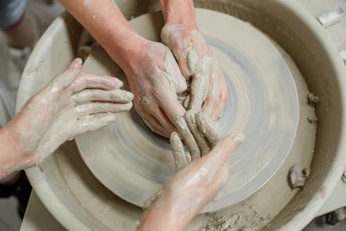 Close-Up Shot of Two People Making a Pot