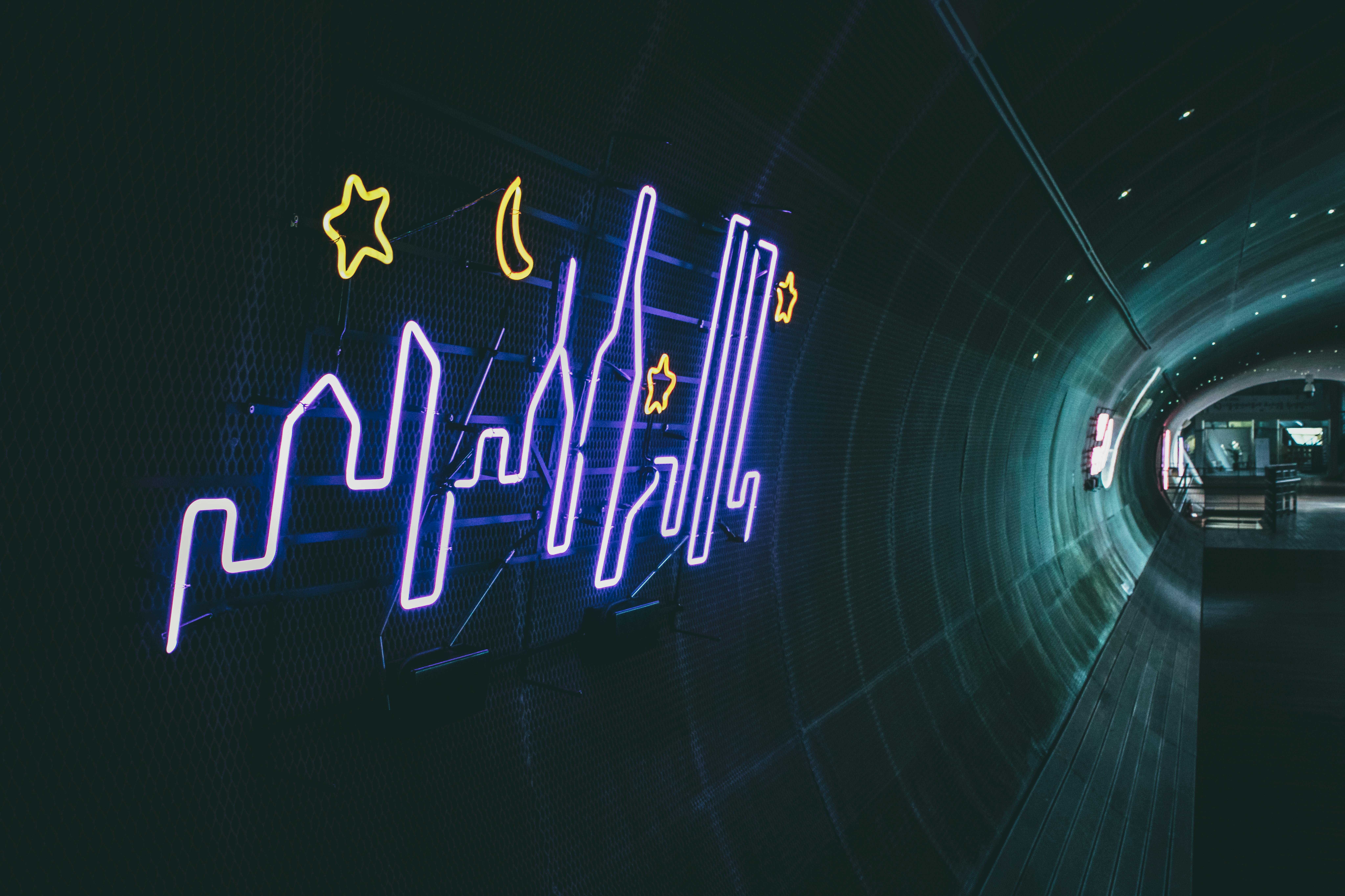 Vibrant neon skyline artwork illuminating a tunnel in Seoul, South Korea.