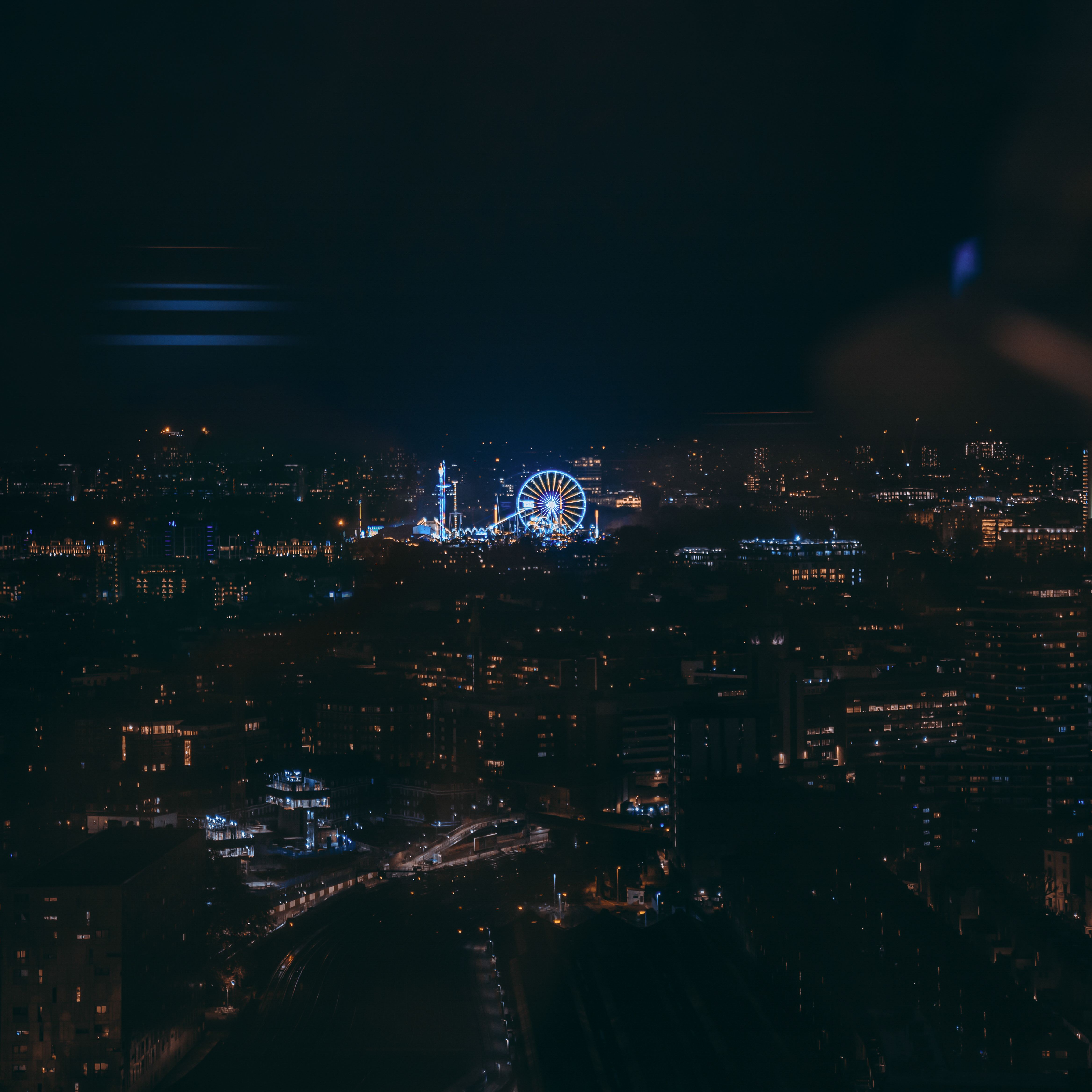 Capture of London's vibrant city lights and ferris wheel at night.