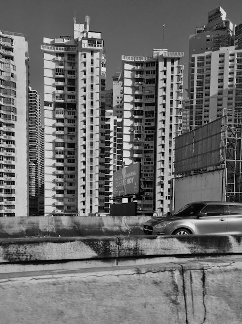 Grayscale Photo of Concrete Buildings