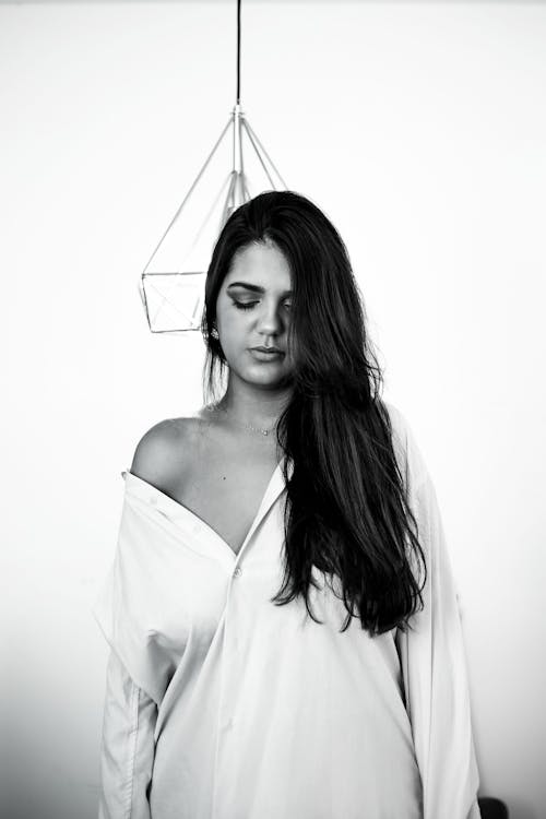 Woman in Shirt Posing on Wall Background