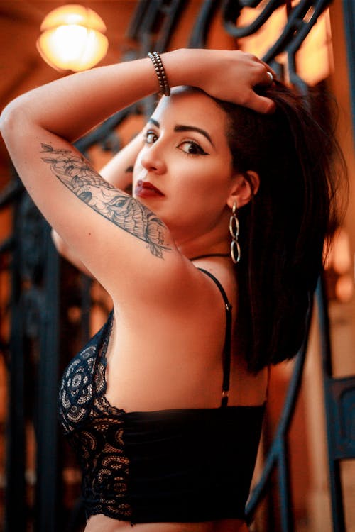 Young Woman with Tattoos Posing in Lingerie