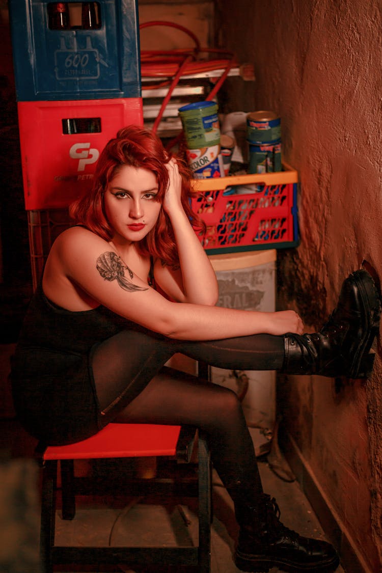 Young Woman With Red Hair Posing On A Chair 