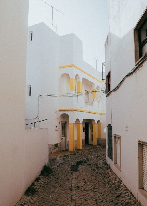 Free Rustic charm of narrow streets and white architecture in Albufeira, Portugal. Stock Photo