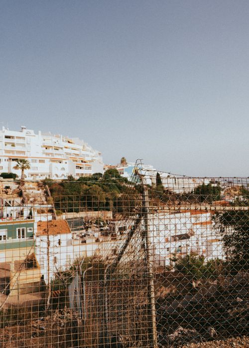 Free A scenic view of urban Albufeira, Portugal, showcasing residential buildings on a sunny summer day. Stock Photo