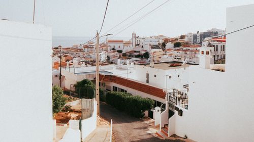 Free Scenic hillside view of Albufeira's white buildings basking in summer sunlight, Portugal. Stock Photo