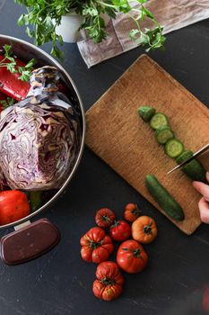 Overhead view of fresh vegetables being chopped on a kitchen counter for a healthy meal.