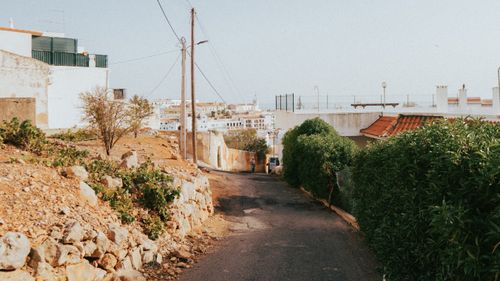 Free A sunny street scene in Albufeira, Portugal, depicting a narrow alley with coastal views. Stock Photo