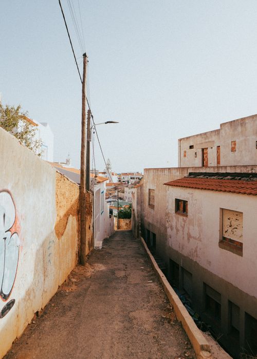 Free Charming alleyway view in Albufeira, Portugal showcasing traditional architecture and urban landscape. Stock Photo
