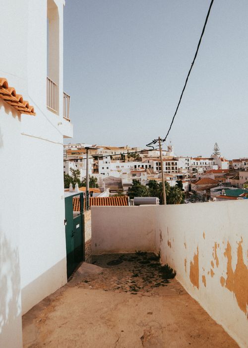 Free Explore the warm ambiance of Albufeira's architecture in this picturesque summer capture. Stock Photo