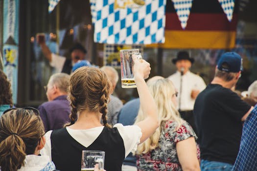 A lively crowd enjoys Oktoberfest outdoors with beer mugs raised. Perfect for festival season visuals.