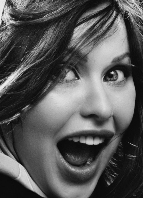 Free Close-up of a joyful woman's face in black and white, showcasing her expressive features. Stock Photo